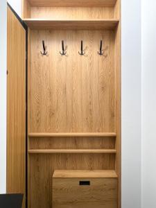 a wooden closet with wooden shelves at Rio Apartamenty Żłobizna in Złobizna
