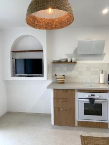 a kitchen with a sink and a stove top oven at Appartement vue mer tout confort in Villeneuve-Loubet