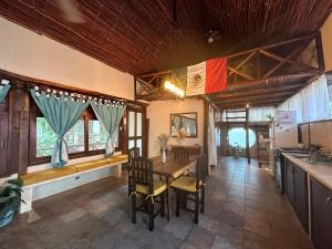 a kitchen and dining room with a table and chairs at Treehouse Loft in Prime Location in Playa del Carmen