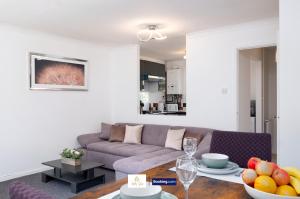 a living room with a couch and a table with fruit at Centrally Located 3 Bedroom House By Trinity Stays Short Lets & Serviced Accommodation Cambridge in Cambridge