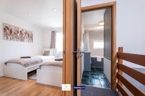 a room with a bed and a door leading to a bedroom at Centrally Located 3 Bedroom House By Trinity Stays Short Lets & Serviced Accommodation Cambridge in Cambridge