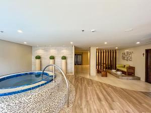 a large bathroom with a jacuzzi tub at Modern 1BR w Exclusive Pool Access in Lapu Lapu City +39 photos