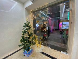 a christmas tree in front of a store window at Eco Nest Apartment & Hotel Nam Ngư in Hanoi