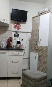 a kitchen with a white refrigerator and a stool at casa lidia in Brăila