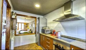 a kitchen with a sink and a stove at El Cerrito de la Vega in La Virgen de la Vega