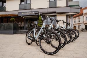 a row of bikes parked in front of a building at Hotel Jeruzalem in Ljutomer