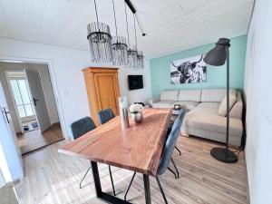 a living room with a wooden table and a couch at Ferienhaus an der Stadtmauer in Furth im Wald
