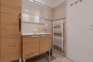 a bathroom with a sink and a mirror at Disney Cosy Cottage, 5 minutes Disneyland! in Magny-le-Hongre +52 photos