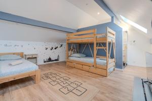 a bedroom with two bunk beds and a table at Disney Cosy Cottage, 5 minutes Disneyland! in Magny-le-Hongre