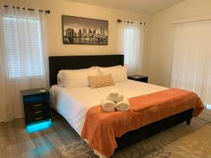 a bedroom with a bed with two towels on it at The Elegant Suite in Shared House in Cape Coral