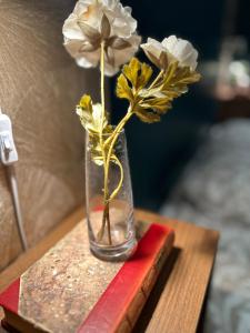 a vase with flowers in it on a table at Elegant Villa Studio in Malmö