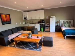 a living room with a couch and a table at 3 on Nebraska Accommodation in Bellville