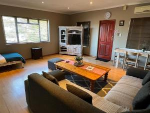 a living room with two couches and a coffee table at 3 on Nebraska Accommodation in Bellville