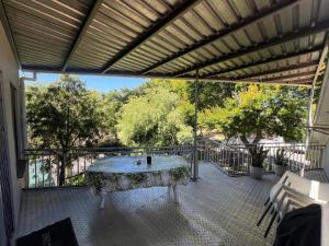a screened in porch with a table on a patio at 3 on Nebraska Accommodation in Bellville