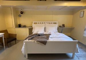 a bedroom with a white bed in a room at Lofoten Cottages by Nusfjord in Nussfjord