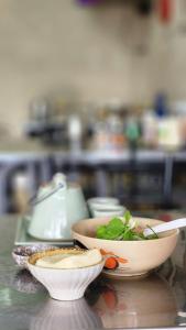 a table with two bowls of food on it at Yenta4fafad in Ban Na Ta Luang (1)