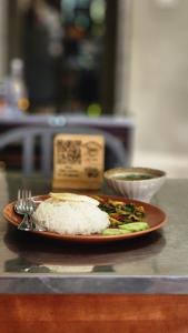 a plate of rice and vegetables on a table at Yenta4fafad in Ban Na Ta Luang (1)