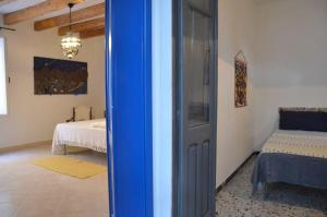 a room with a bedroom with a bed and a window at Guest House Sa Succargia in Baunei