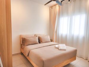 a small bedroom with a bed with a window at Flora Residency KL -- Botanical Vibes #3BR2B #1-7 pax by Cowidea in Kuala Lumpur