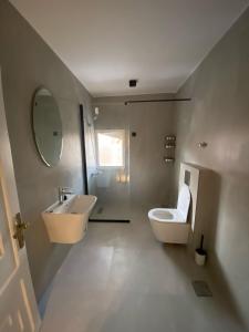 a bathroom with a sink and a toilet and a mirror at Al Salehiyah 2 in Medina +19 photos