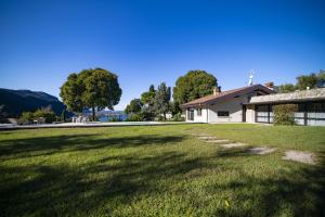 a large yard in front of a house at Villa Anna Lake View in Pilzone +73 photos