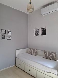 a white bedroom with a bed in a room at Kozani room with a view! in Kozani