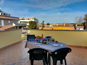 a table and chairs on a patio with a view of a building at RicHouse by Holiday World in Fiumicino