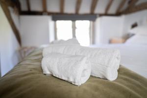 a pile of towels sitting on top of a couch at Seven Abbey Lane in Southam