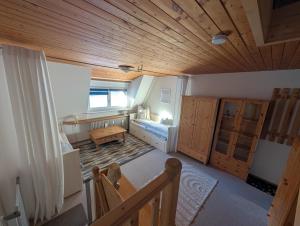 a room with a bed and a wooden ceiling at Ferienwohnung Eule in Schönwald