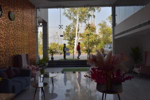 a living room with a person walking in a building at Country Ambience Hotel in Haldwāni