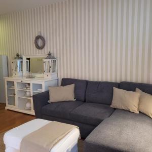 a living room with a blue couch and a mirror at Lux apartament Poznań, ul. Mostowa 19 D/5 in Poznań +26 photos