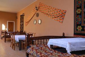 a dining room with two tables and a flag on the wall at Prime Villa Hotel in Tashkent