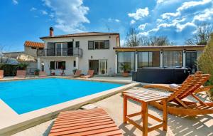 a villa with a swimming pool and a house at Beautiful Villa Lara with sauna in Imotski in Kamenmost