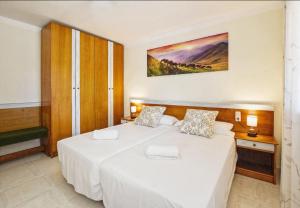 a bedroom with two beds and a painting on the wall at Finca Son Cladera Petit in Son Macia +14 photos