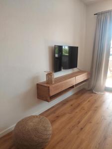 a living room with a flat screen tv on a wall at Ferienwohnung Stephanie im Landhotel Seeg in Seeg