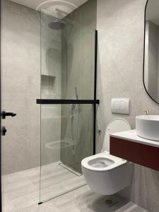 a bathroom with a shower and a toilet and a sink at Krug in Loznica +8 photos