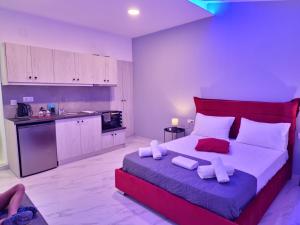 a large bedroom with a large bed and a kitchen at George Studios in Alepou