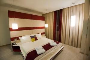 A bed or beds in a room at AS Hotel Limbiate Fiera