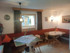 a dining room with two tables and a window at Haus Gilfert in Weerberg