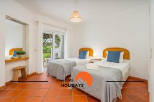 two beds in a room with two tables at #250 Apartamento 264 by Home Holidays in Branqueira +39 photos
