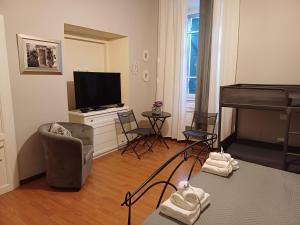 a living room with a television and a piano at B&B Home XIX in Narni