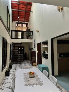 a dining room with a table with a bowl of fruit on it at The Kumberi Manor in Ammatti