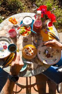 a person sitting at a table with plates of food at Agriturismo Morani in Santa Severa