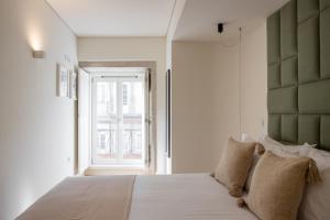 Postel nebo postele na pokoji v ubytování ORM Batalha Apartments