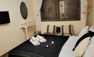 a bedroom with a bed with towels on it at blue perl appartement haut standing luxury services in Essaouira +29 photos