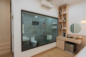 a bathroom with a glass shower and a toilet at Thiên Trường An Garden in Ninh Binh