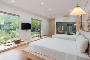 a bedroom with two beds and a large window at Thiên Trường An Garden in Ninh Binh +50 photos