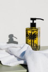 a close up of a bottle of soap and a towel at Domìa Boutique Hotel e Cucina in Mondello