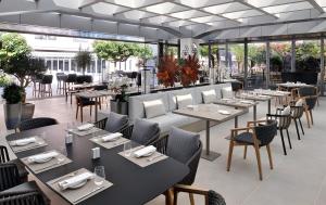 a restaurant with tables and chairs and windows at Creston Suites The Dubai Mall Residences in Dubai