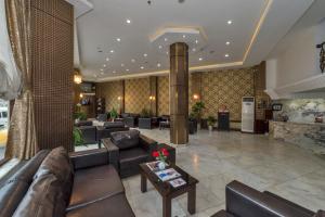a lobby of a hotel with couches and a table at Kuran Hotel International in Istanbul